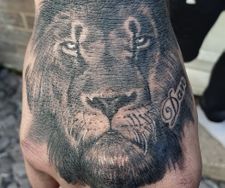 lion hand tattoo realistic black grey
