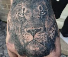 lion hand tattoo realistic black grey