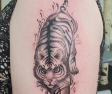 stylised tiger black grey tattoo arm piece manchester